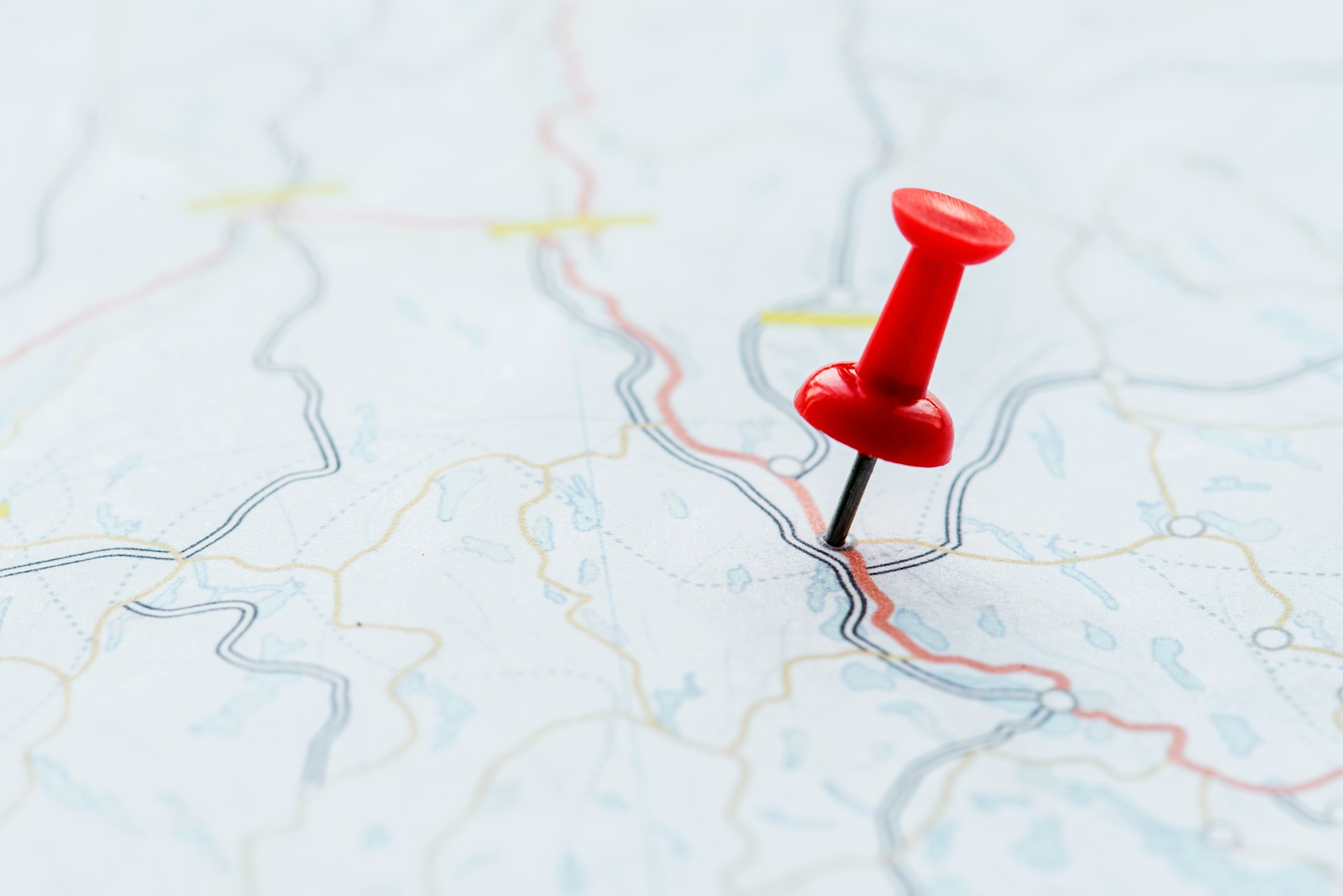 a red pin on a paper map